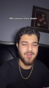 Guy Looking at Microwave