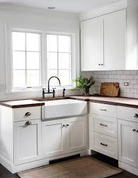 white shaker kitchen cabinets with wood