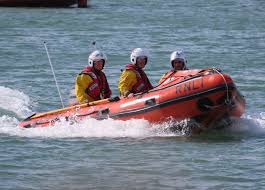 The RNLI has thanked a quick-thinking teenager who went out on his own boat  to rescue two men who got into difficulty after falling from a toy blow up inflatable  boat off