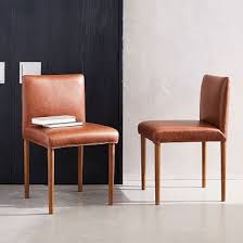 Standing On Slim Wooden Legs For An Airy Feel Our Ellis Dining Chair Has All The Right Angles Its Dining Room Design Dining Chairs Faux Leather Dining Chairs