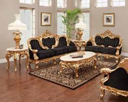 An emerald green velvet chair sits in a living room beside a round brown leather pouf. 10 Black And Gold Living Room Ideas 2021 The Reverse Mix