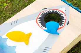 Others like to scissor the corner so that the corner of the bean bag is split between their index and middle finger. Diy Shark Week Cornhole Boards Hgtv
