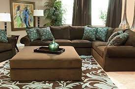 The large plant on the coffee table helps add some lightness to the dark. Hausratversicherungkosten Captivating Aqua Brown Living Room Ideas In Collection 4878