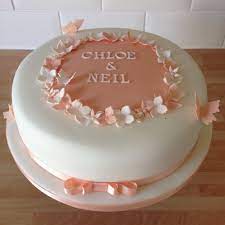 A ribbon of textured white icing adds dimension across the tiers. Simple Peach Engagement Cake Engagement Cakes Engagement Cake Design Simple Birthday Cake