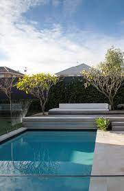 Raised Decking Above Pool With A Built In Lounge Chair And Frangipani Trees Growing Through Decking T Decks Around Pools Pool Planters Swimming Pools Backyard