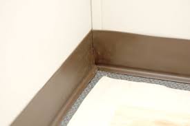 Using your gloved hand and the putty knife, pull the trim from the wall gently as the glue warms and releases the vinyl. How To Install Vinyl Wall Base