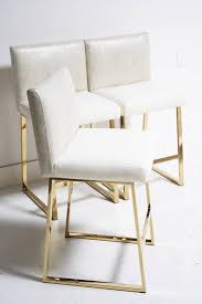 Glossy white finish and chairs are stackable. 9 Furniture Refinishing Tips With Scout Design Studio Domino Upholstered Dining Chairs Gold Dining Chairs White Dining Chairs