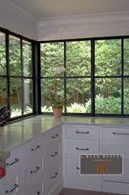 A Close Up Of The Custom Metal Corner Window By Rod Gibson This Window Provides A View To The Driveway Window Construction Traditional Kitchen Iron Windows