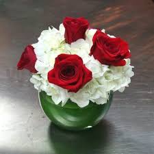This bouquet features blue hydrangea, red roses, white asiatic lilies, red alstroemeria, white carnations, blue delphinium, white snapdragons, huckleberry, dusty miller, aralia leaf and lemon leaf. Red Roses With White Hydrangeas Lillian Michiels Red Roses Centerpieces Red Rose Centerpiece Wedding Picture Wedding Centerpieces