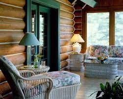 On A Log Cabin S Porch Wicker Furniture Cabin Living Cabin Interiors Home