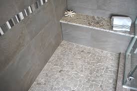Light Gray Pebble Mosaic Shower Floor With Gray Stone Wall Tile Master Bathroom Inspiration Shower Floor Stone Shower Floor Pebble Tile Shower
