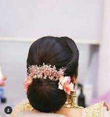 What A Beautiful Large Low Bun With Real Flower Gajra Care However Should Be Taken Before Adopting Indian Bridal Hairstyles Bridal Hair Buns Indian Hairstyles