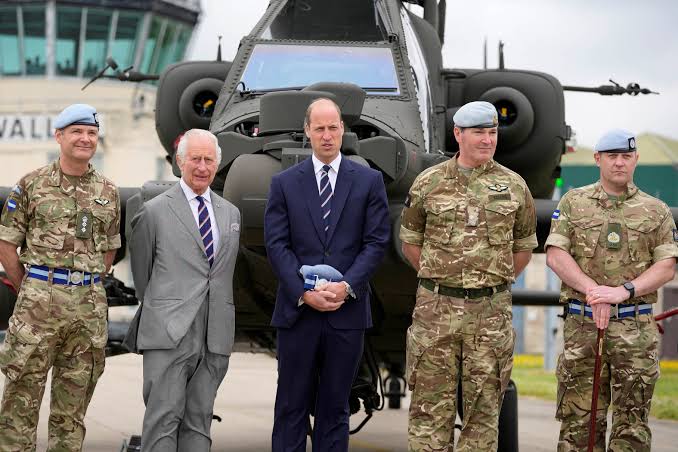 King Charles hands military title to son William in rare joint appearance |  Reuters