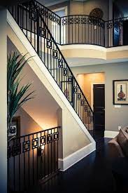The white walls contrast with the striking dark railing. Modern Railing Design Southern Staircase Artistic Stairs