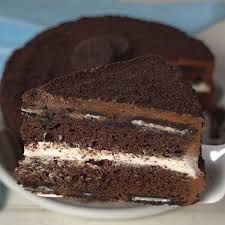 This Oreo Cake Is A Surprise Inside Cake With Chocolate Layers An Oreo Filling Covered In Chocolate Buttercream And T In 2020 Oreo Cake Recipes Cake Recipes Desserts
