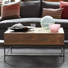 Lofted on airy steel legs, the solid mango wood body has enough room to stow anything from toys and remotes to pillows and throws. Rustic Storage Coffee Table West Elm Coffee Table With Storage Coffee Table Coffee Table Wood