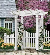 The arbor fence and gate with wings are so beautiful. Picket Fence Ideas For Instant Curb Appeal Garden Gates And Fencing Garden Arch Garden Arbors