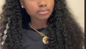 Black girl sewin two ponytails with hair down in back