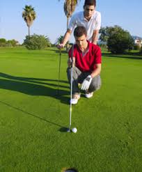 Features a ball and tee in the foreground and duffer in the background. Free Golf Lessons Online Golf For Beginners Pdf