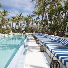 Soho Beach House Miami A Pool With Striped Loungers And Tropical Plants Soho Beach House Miami Miami Beach House Soho Beach House