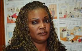 Rally drivers Anwar Sidi (left) and Keith Henrie feed a dehydrated cow in  Naivasha, Wednesday. Hundreds of animals have succumbed to drought.