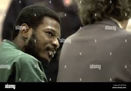 Anthony Lamar Bailey, accused of fatally shooting three of his children and  seriously wounding another, speaks to his attorney during his preliminary  hearing in district court in Detroit, Monday, Nov. 17, 2003.