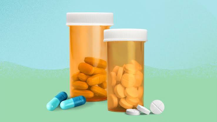 Person at home comparing medicine packaging with pharmacy receipt and barcode verification