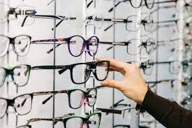 Eyeglasses Shop Stand With Glasses In The Store Of Optics Woman S Hand Chooses Glasses Costco Shopping Hacks Eyeglasses For Women