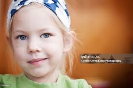 Blond Girl With Bandana And Slight Crooked Smile High-Res Stock Photo