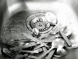 steel kitchen sink with dirty utensils