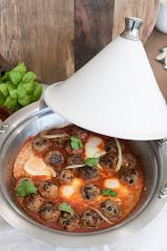 Lamb meatball tagine a tagine recipe using lamb mince, spices, apricots, onions, garlic, cinnamon, chopped tomatoes, lamb stock, freshly chopped coriander and honey. Lamb Kofta Tagine With Tomatoes And Eggs Kitchen To Table