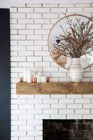 You can paint a brick fireplace in a single weekend with a little bit of preparation and some effort. White Brick Fireplace With Reclaimed Wood Mantel And Round Mirror Orlando Interior Designer S Home Renovation White Brick Fireplace Brick Fireplace Decor