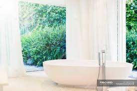 The space surrounding the freestanding tub makes the room feel more open, as does the lightweight curtain fabric, which allows maximum. Bathtub Curtain And Windows In Modern Bathroom Color Image Wealth Stock Photo 199731758