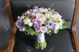 Maybe you would like to learn more about one of these? Brides Wedding Bouquet With Peonies Freesia And Other Flowers On Black Arm Chair Light And Lilac Spring Color Morning In Room Stock Photo Picture And Royalty Free Image Image 99724083