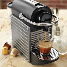 This machine makes coffee by running hot water through ground coffee beans. Nespresso Pixie Espresso Machine Williams Sonoma