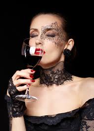 Portrait Of Beautiful Brunette Woman Sommelier In Lacy Black Dress And  Gloves With Face Body Art Holding Glass Of Red Wine In Hand With Eyes Shut  Stock Photo