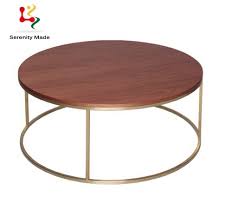 Our sahara coffee table is handmade of mango wood in a graceful bowl shape accented with intricately detailed, geometric antique brass cladding. China Foshan Factory Cheaper Price Round Wooden Coffee Table Hote Side Table With Brass Base China Dining Table Wooden Coffee Table