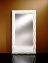 A vanity mirror with led or halogen light bulbs is preferable to one with integral led lights because larger bulbs produce more light, evenly distributed minimalistic setting for a compact bathroom with a long sink counter with a top made out of slate stone and a frame made out of light wood, all paired. Large Mirror Nick In White Wilhelmina Designs