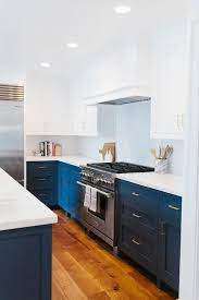 White And Navy Blue Kitchen Features White Upper Cabinets And Navy Lower Cabinets Painted Ben Modern Kitchen Remodel Kitchen Design Decor Kitchen Remodel Small