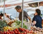 Image of bustling market with agricultural produce