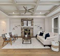 A steep vaulted ceiling, finished with white wood planks, creates a bright, airy feel in the master bedroom of this waterfront home. Box And Beam Tray Ceiling Detail Beams Painted In Sherwin Williams Mindful Gray Sw7016 Box And Beams Living Room Ceiling Beams Living Room Family Living Rooms