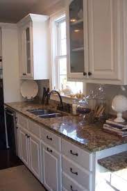 White cabinets with earth tone back splash and tan granite. White Cabinets Brown Granite Countertops Kitchen Renovation