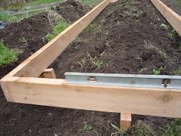 If you choose to use corner posts, lay out a hose or string to define the boundaries of your garden. How To Build A Raised Garden Bed On Sloping Uneven Ground Eartheasy Guides Articles Eartheasy Guides Articles