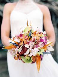 Our talented team of florists can match your color scheme with a variety of tropical flowers you may not even be aware of. Inspired By This Outdoor Hawaiian Wedding By Wendy Laurel Inspired By This Tropical Wedding Bouquets Hawaiian Wedding Wedding Bouquets