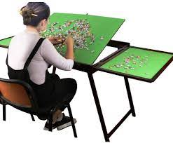 Jigsaw puzzle tables come in all sizes some sit on other tables, some are stand alone, but most of them are folding tables. Amazon Com Wooden Jigsaw Puzzle Table For Adults Kids Large Portable Folding Table With Storage Cover Fold And Go Tilting Table Multifunction Home Furniture Puzzle Accessories For 1500 Pcs Toys Games