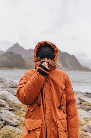 When The Weather Is Harsh A Zipped Up Parka Might Be Your Best Friend Parkas Fashion Orange Lofoten Lifestyle Out Down Parka Parka Casual Wear For Men
