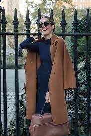 The obvious strength of the camel coat is its dapper appearance. Louise Roe Wearing Fall Outfit With Navy Dress And Camel Coat 2 Front Roe By Louise Roe