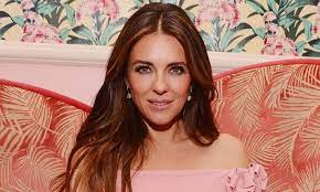 Elizabeth Hurley Wows In White Swimsuit In Sun Soaked Beach Photo In 2021 Elizabeth Hurley White Swimsuit Elizabeth Hurley Beach