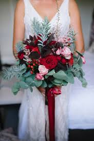 Wedding bouquets with king proteas. A Bold And Dimensional Wedding Bouquet With Dark Leaves Red And Pink Blooms Eucalyptus And Other Red Bridal Bouquet Red Wedding Theme Winter Wedding Bouquet