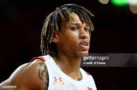 Dan Friday of the Brown Bears handles the ball against the Maryland... News  Photo